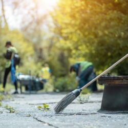 people cleanup city park from garbage with janitor equipment and tools